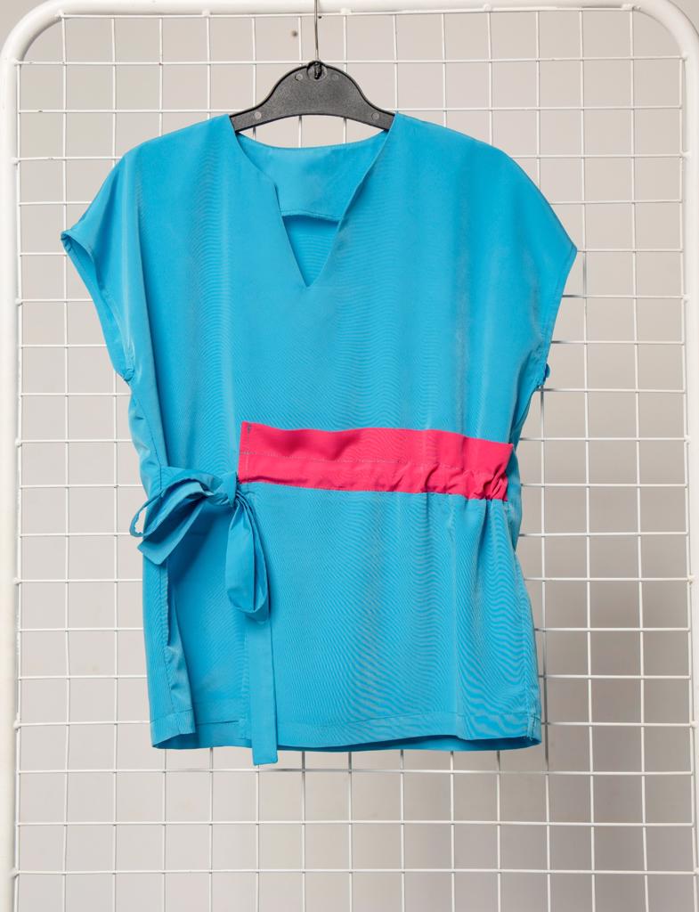 Product image - Maternity friendly adjustable scrub top. Available in various bright or darker colours. Fabric is water resistant. Sizes range from 28 to 50.